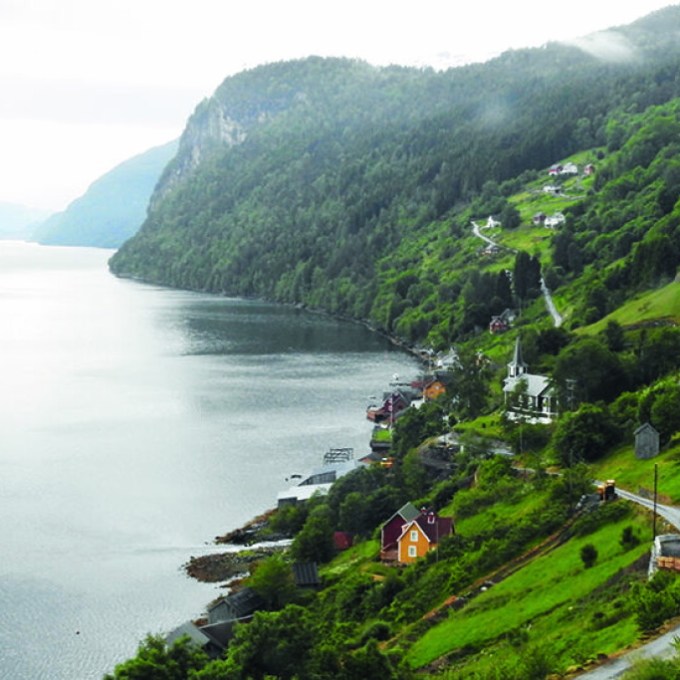 a large body of water with Waipio Valley in the background