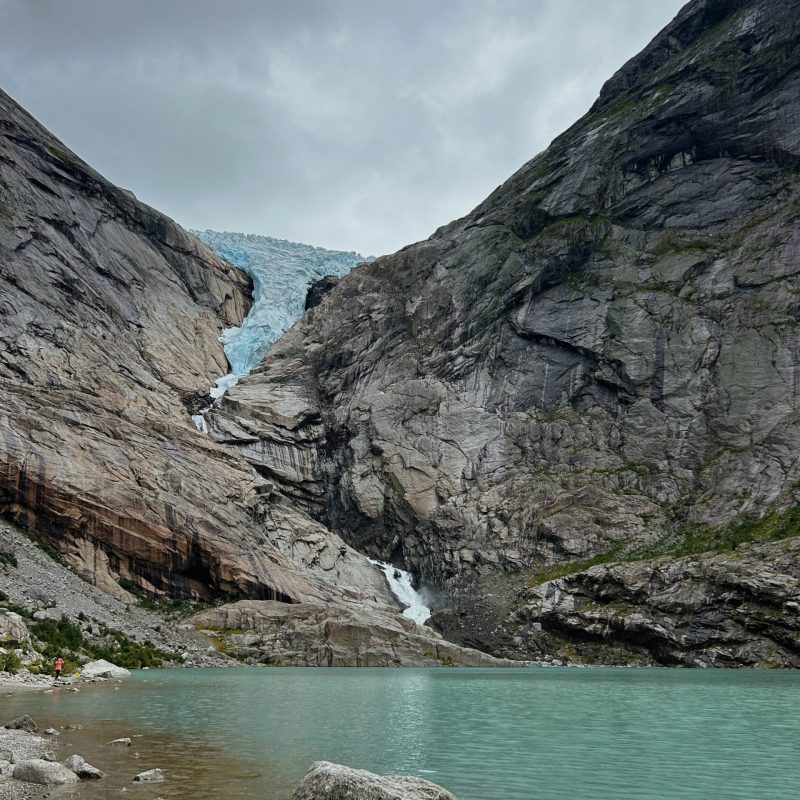 a body of water with a mountain in the background