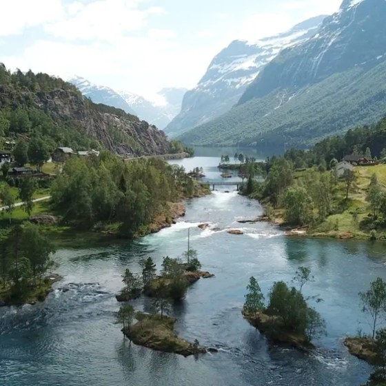 Scenic view of a river flowing through a valley with mountains in the background.