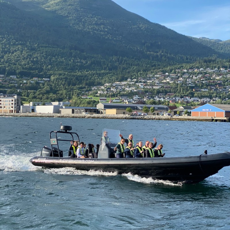 a group of people on a boat in a large body of water