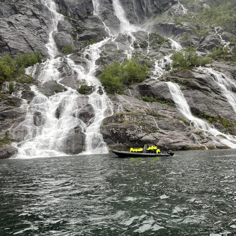a large waterfall over a body of water