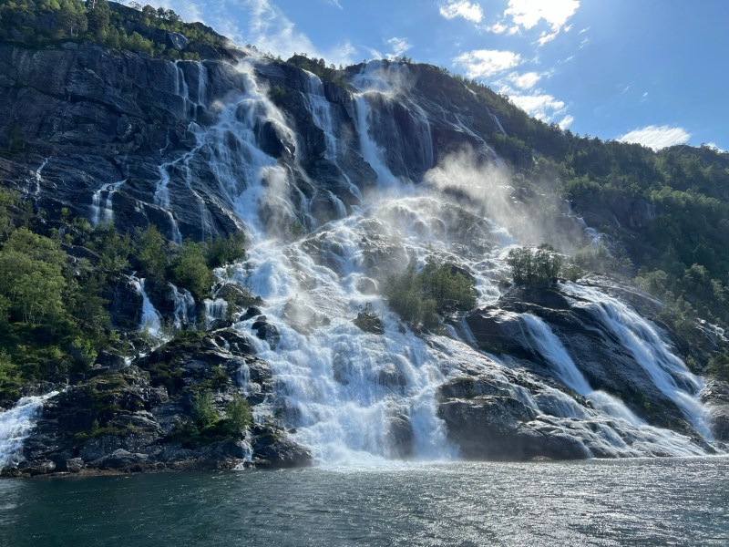 a waterfall with a mountain in the background