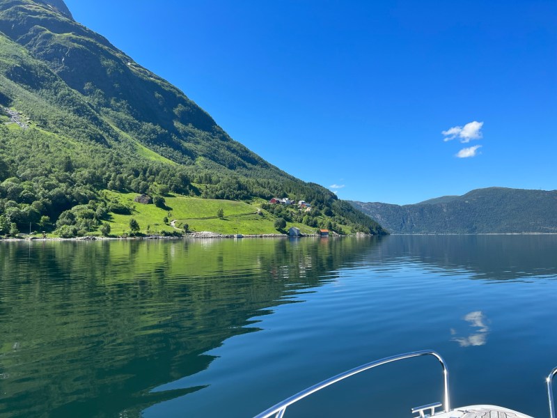 a large body of water with a mountain in the background