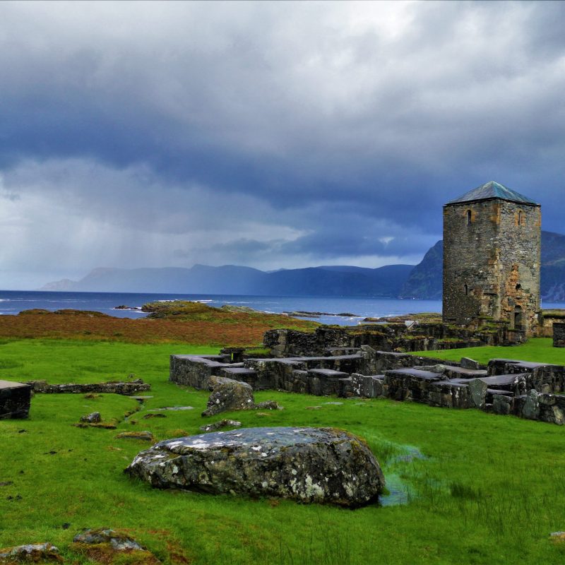 a castle on top of a lush green field